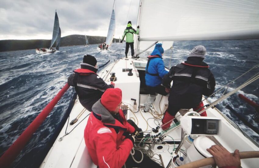 A group of friends are sailing on a boat.