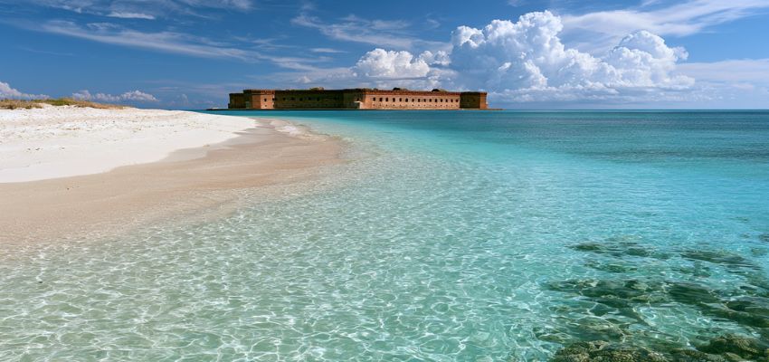 Crystal-clear shallows near a historic fort, showcasing the warmest place in Florida.