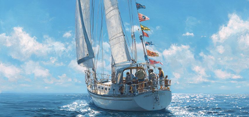 A white-hulled sailboat sailing on calm blue ocean waters, with nautical flags in various bright colors like red, yellow, blue, and multicolored flown from the mast and rigging, crew members visible on deck under a partly cloudy sky.