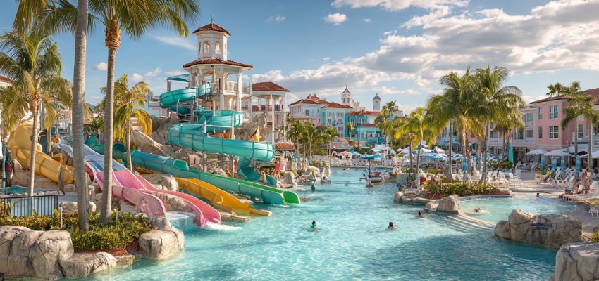 Colorful water slides and sparkling pools at a lively water park surrounded by palm trees in Boca Raton, showcasing fun things to do Boca Raton for families and thrill-seekers