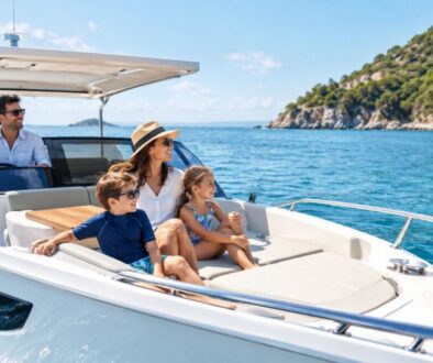 Happy family relaxing on the deck of a small yacht cruising coastal waters.